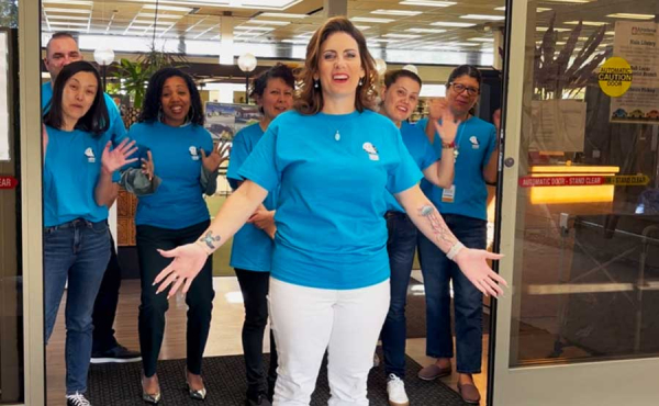 people standing by door smiling