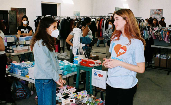 two girls standing by donations