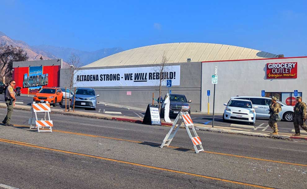a sign on a store vowing to rebuild