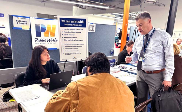 a woman behind a desk helping someone