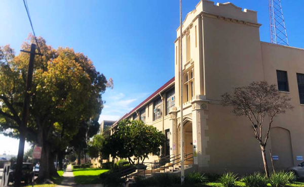 a building with trees and a tower