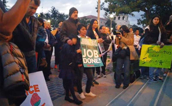 people gather on step of city hall