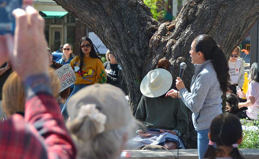 a woman speaking to the crowd