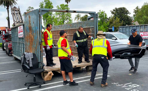 people moving a bulky item