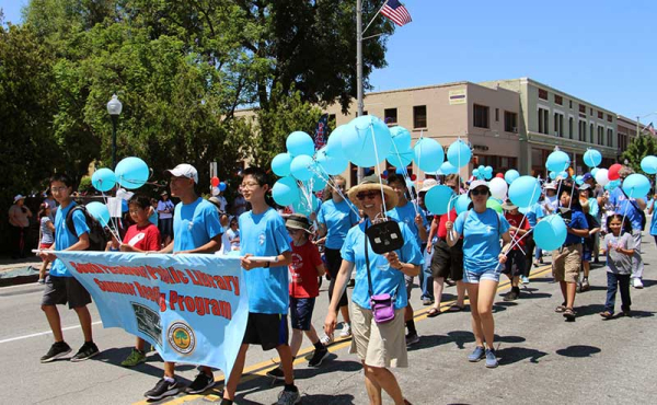parade attendees holding balloons