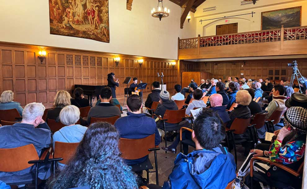 musicians playing in a room full of people
