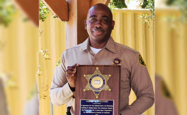 A man holding a commemorative plaque