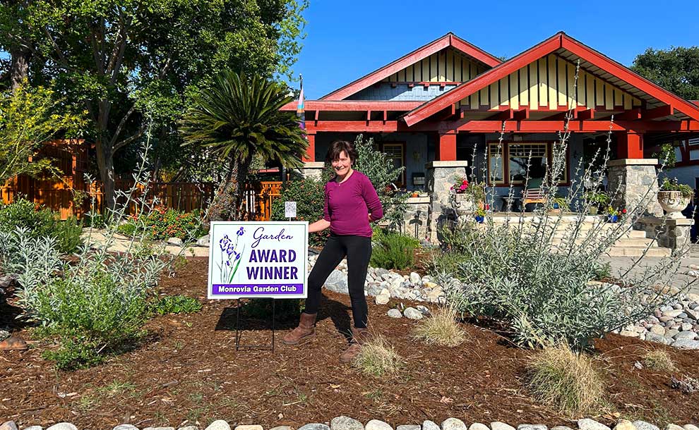 a woman standing by a sign