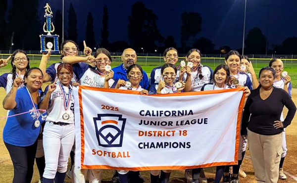 a softball team holding a banner