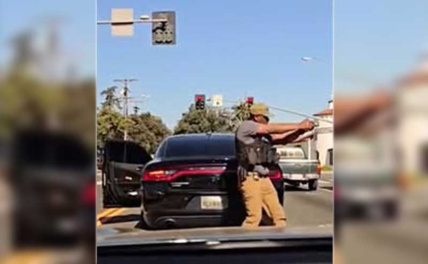 a masked man pulling a gun on citizens