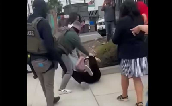 a man pushed to the ground and arrested