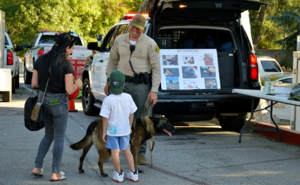 A family conversing with a police officer