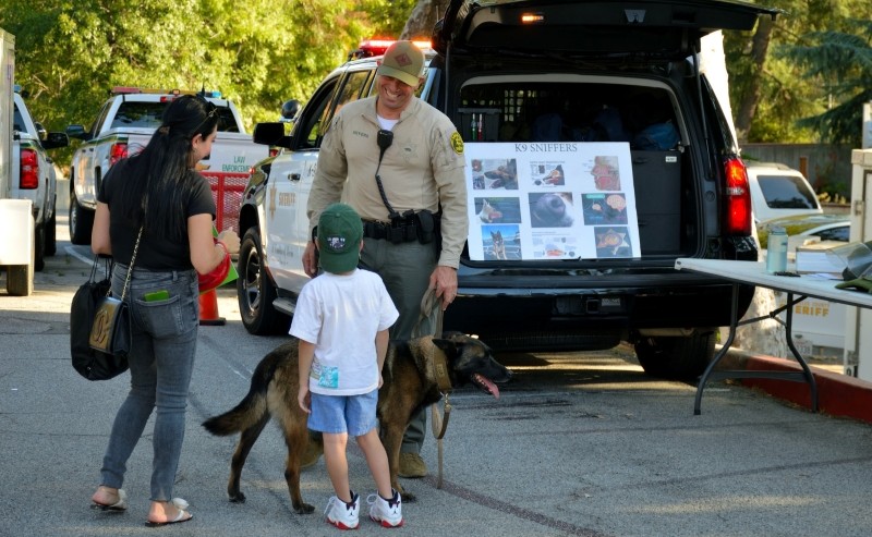 A family conversing with a police officer