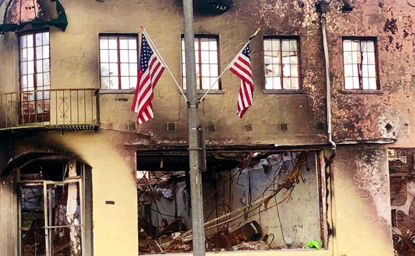 burned building and American flags