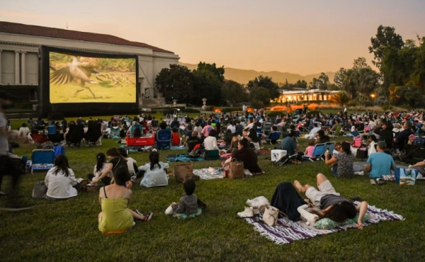 People watching a movie on a lawn