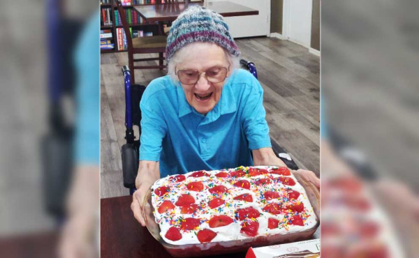 a man smiling at her cake