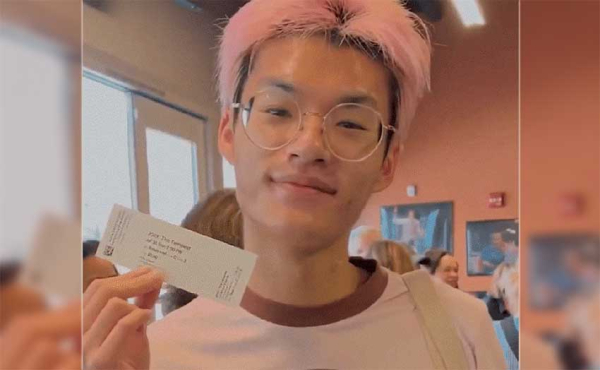 a teen holding a ticket