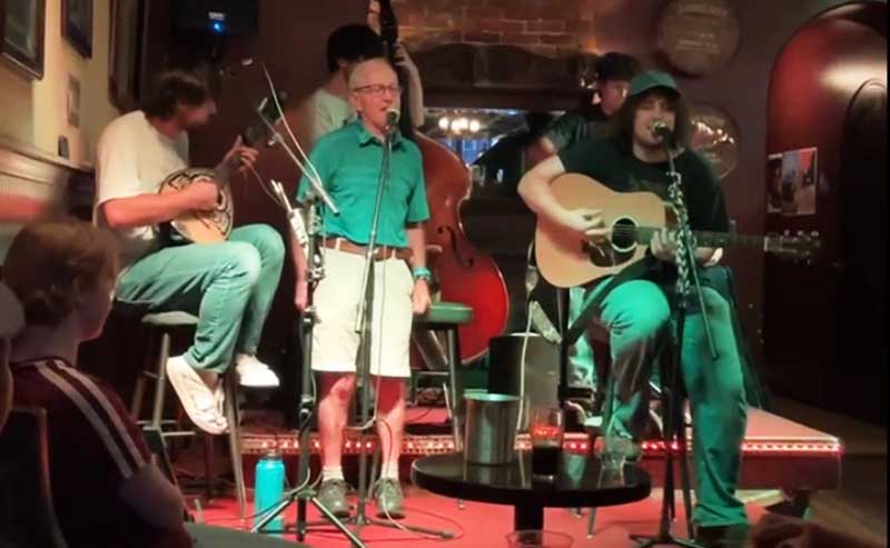 a man singing with a band