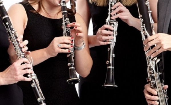 Four people playing clarinets