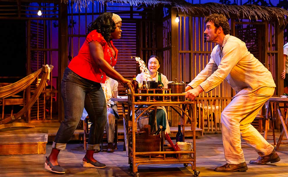 a man and a woman fighting using a food cart