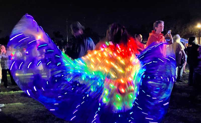 a dancer dressed with lots of lights