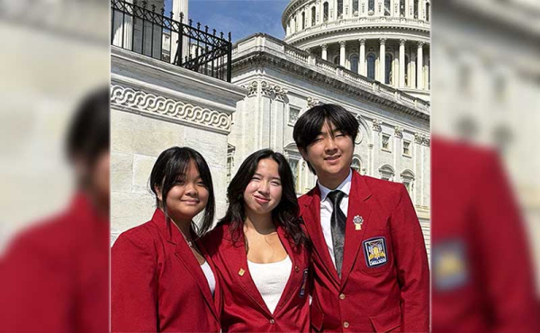 three students smiling