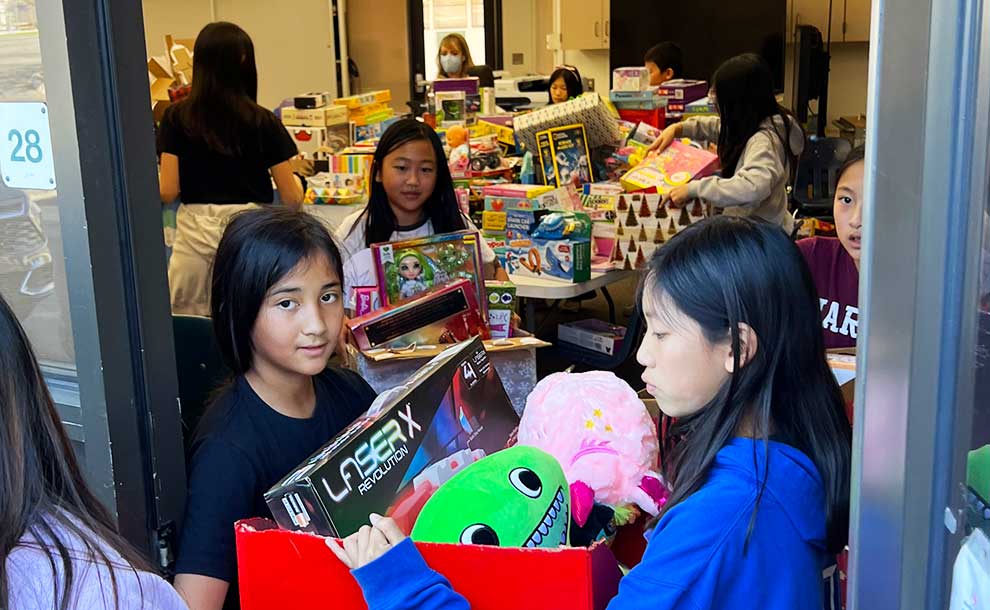 kids moving toys in boxes