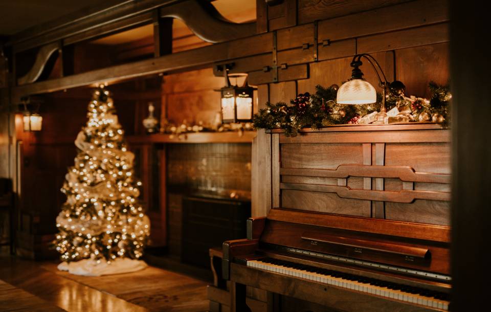 soft yellow glow of Christmas tree and wooden home interior