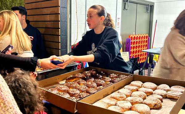 A woman giving out latke