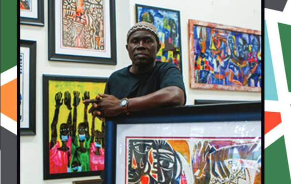 Senegalese-born artist leans on his painting in frame with others hanging behind