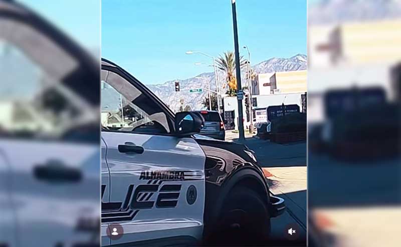 a police car intercepting two parties