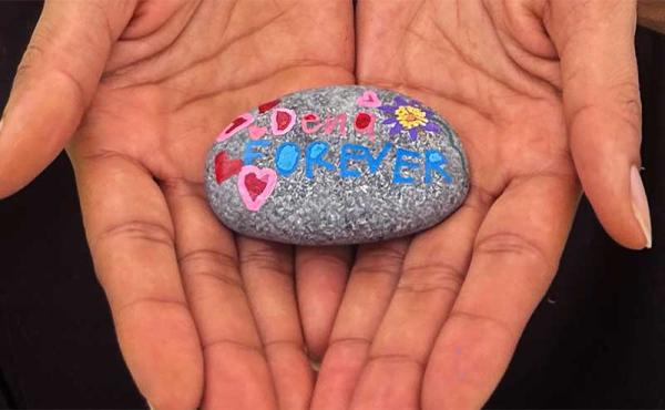 two hands holding a painted rock
