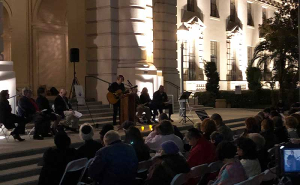 a person playing the guitar and singing