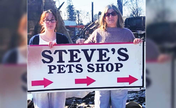two people holding a sign