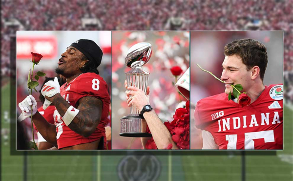 football players holding roses and a trophy