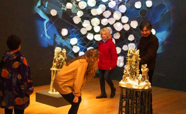 people admiring an art installian