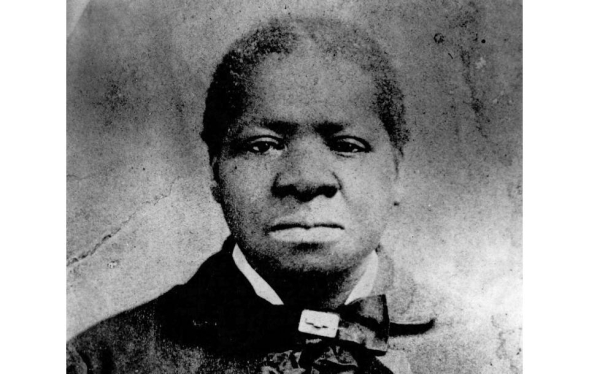 black and white photograph of Black woman in formal wear and kerchief