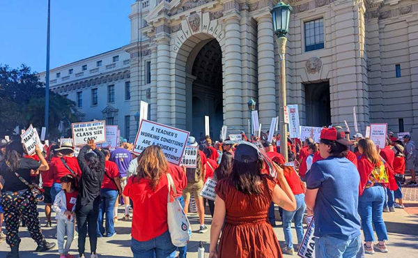 teachers holding signs