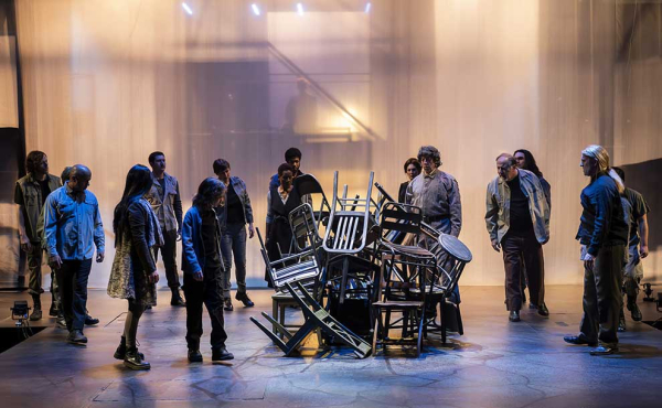 actors around stacked chairs