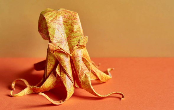 A burnt orange background with a crumpled paper-effect pale octopus