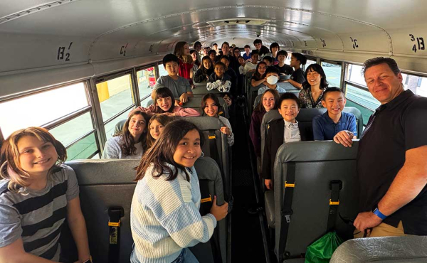 students and teachers on a bus