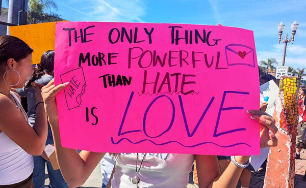 a sign that says: The only thing more powerful than hate is love