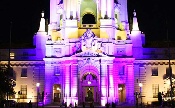 city hall lit up with purple colors