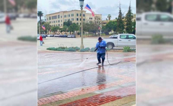 man power washing sidewalk