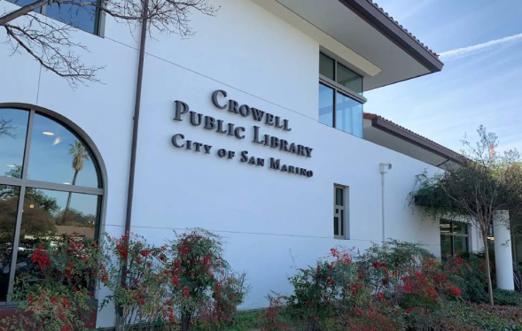 exterior of civic building with large windows and white smooth walls
